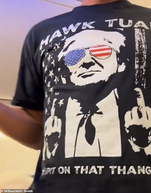 In the clip, the irate traveler can be seen wearing a black T-shirt featuring an image of Trump wearing American flag sunglasses and making the thumbs-up gesture with both hands.