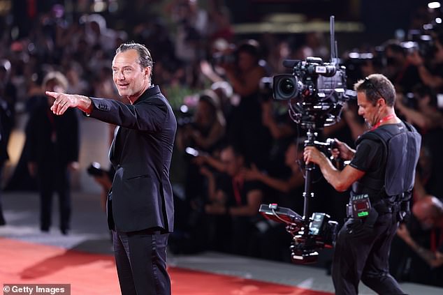 He was also photographed pointing at someone in the crowd and seemed surprised to see them.