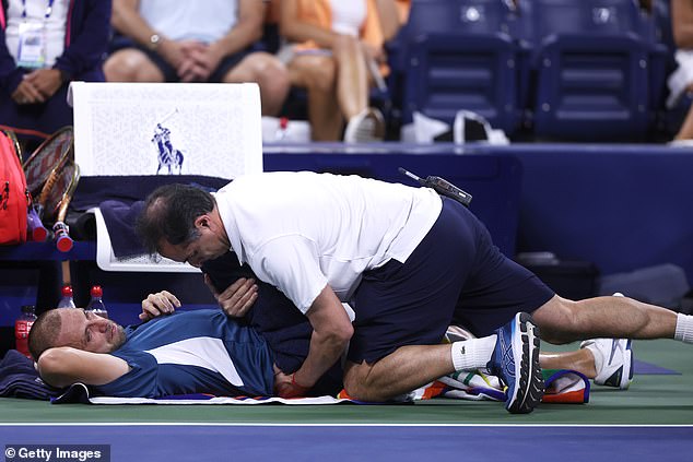 Daniel Evans is treated by Medical Services Director Alejandro Resnicoff between games