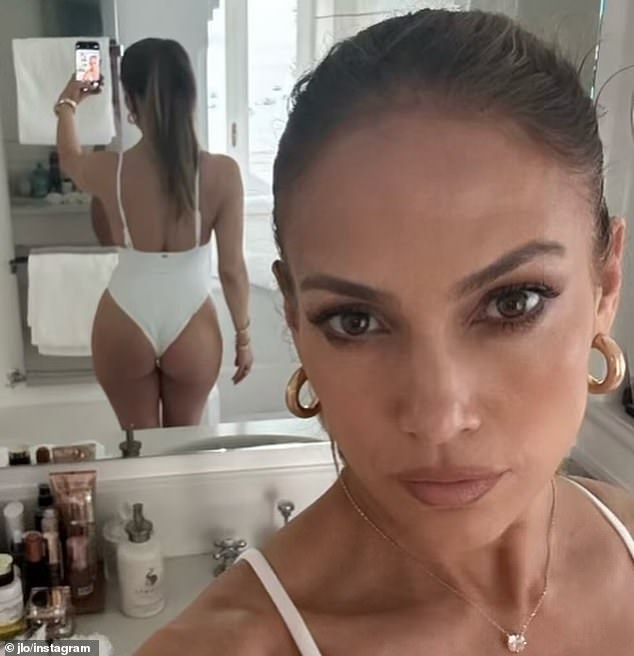 Her post included a steamy selfie in front of her bathroom mirror, taken while wearing a high-cut white swimsuit that showed off her world-famous derriere.