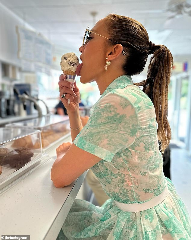 JLo was seen wearing an elegant 1950s floral dress while enjoying ice cream at an ice cream counter, and in a low-cut pink dress at an elegant dinner at a restaurant.