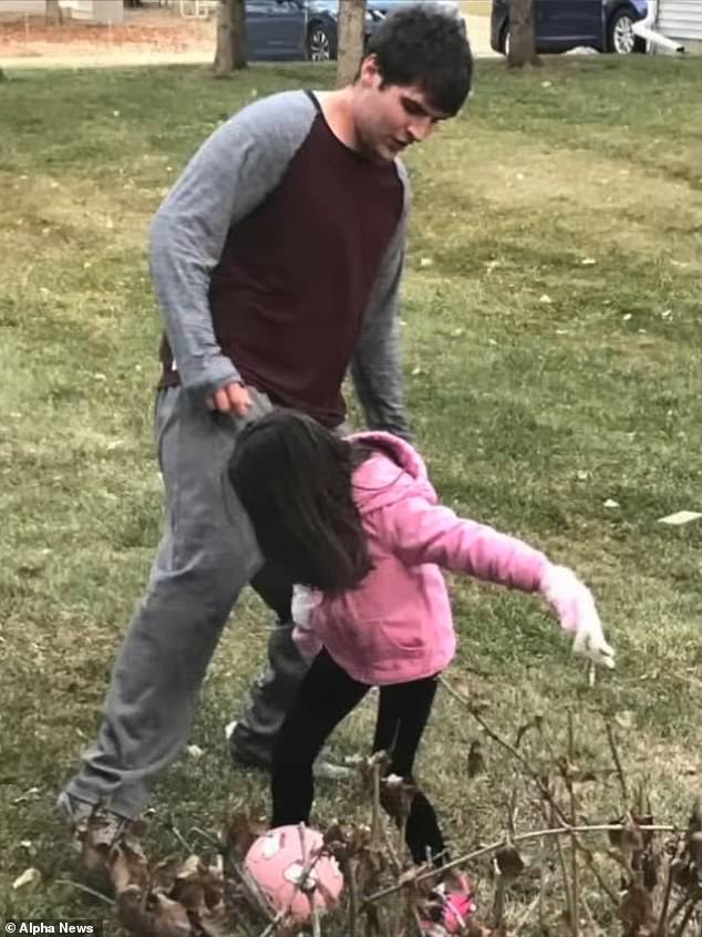 Adams kicks a soccer ball while playing with his sister.