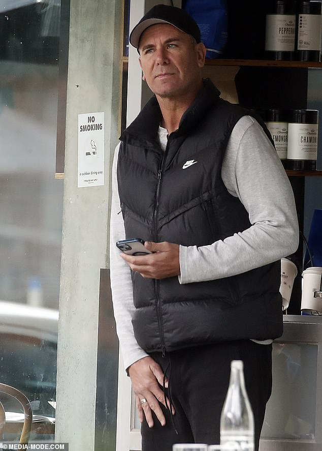 The AFL legend looked comfortable as he stepped out with his family for lunch in a black padded jacket over a white long-sleeved shirt.