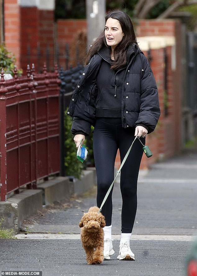 She also opted for a white socks and sneakers combo, and wore her dark hair down for the family outing to the local cafe.