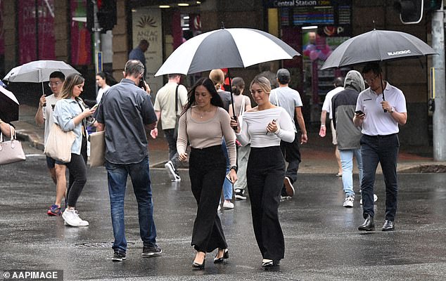 Hobart will be hit by persistent scattered showers for most of the week, while scattered showers are also expected in Melbourne and Adelaide (pictured, people holding an umbrella on a rainy day)