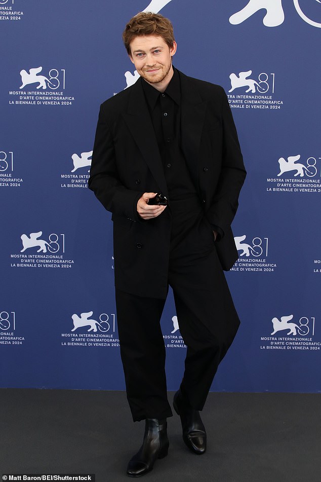 She was joined by fellow actor Joe (pictured), 33, who looked equally dapper in an all-black ensemble, comprising of a black shirt and suit with boots.