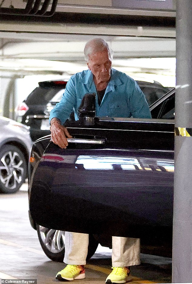 He wore an aquamarine button-down shirt with dark blue buttons and a dark undershirt, as well as a comfortable pair of loose-fitting grey pants. He accessorized his outfit with a pair of bright yellow Nike sneakers and a gold necklace and bracelet.