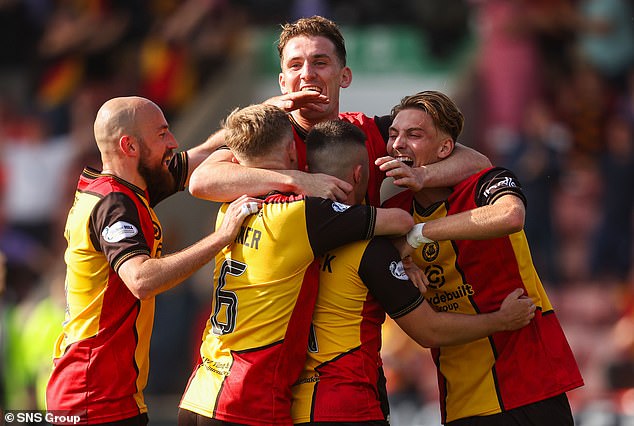 Partick Thistle players celebrate their late goal in a decisive 3-0 win