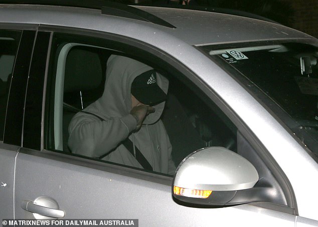 Another man dressed as Amon emerged from the police station from the front wearing a grey hoodie and a similar style baseball cap (pictured).