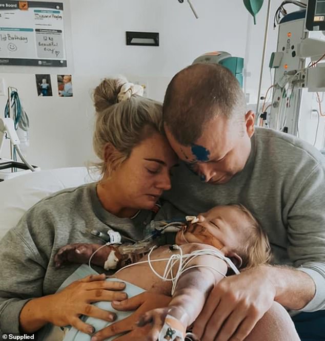 Mrs Read, 36, and her husband Gavin, 38, are pictured with Archie in hospital.