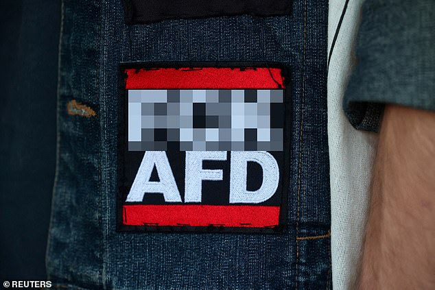 A protester carries a sticker against the Alternative fur Deutschland (AfD) party during a demonstration following the first exit polls in the Thuringia state elections in Erfurt, Germany.