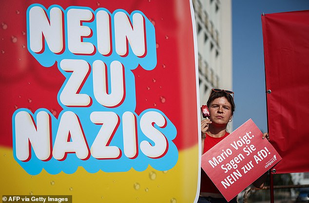 Activists hold banners during a protest against the far-right party AfD (Alternative for Germany) and its top candidate for the regional elections in Thuringia.