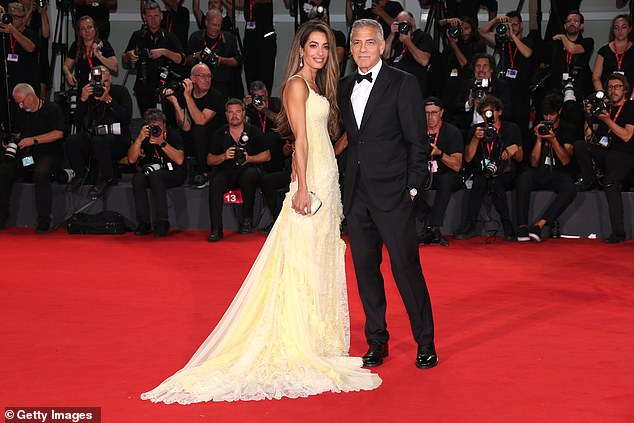 Longtime couple George and Amal Clooney surprised everyone, Amal wearing a vaporous yellow dress