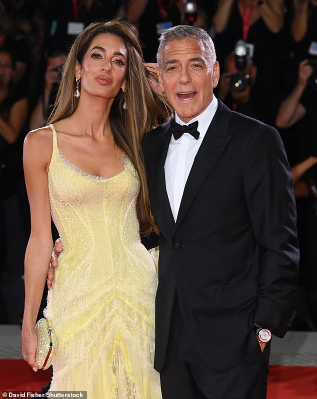 Pitt and Clooney (pictured with wife Amal) were reportedly paid $35 million each to star in the heist film, and had insisted it be released in theaters.