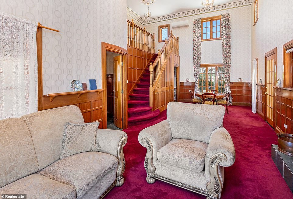 Inside, medieval grandeur awaits, combined with wooden interior elements. There is a formal living room and a dining room fitted with a royal red carpet and a grand fireplace.