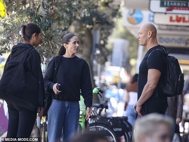 The model stepped out with her father, former Olympic gold medallist Michael Klim, 47 (right) and his girlfriend Michelle Owen (centre) after their stay at the resort destination.