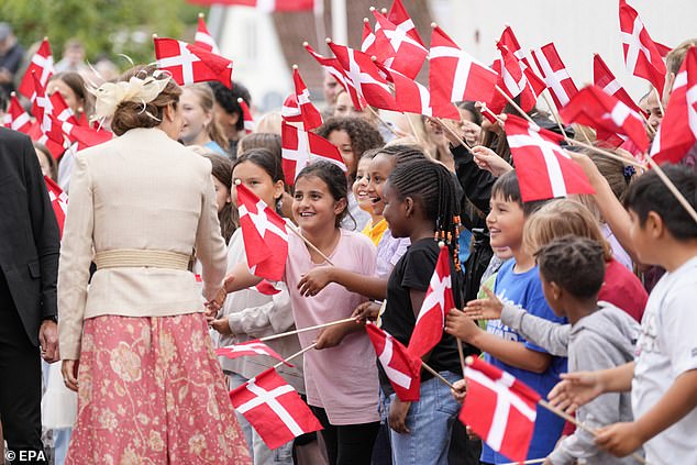 Queen Mary greets children on her visit to the Peter Willemoes school in Assens. People queued to greet the royals at every stop