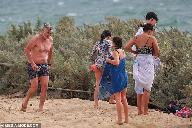 Dave seemed proud to be in the company of his family, and appeared to share a joke as they headed back to the car after the beach visit.