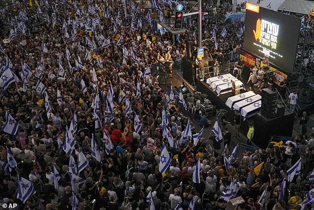 People take part in a protest in Tel Aviv, demanding a ceasefire agreement.