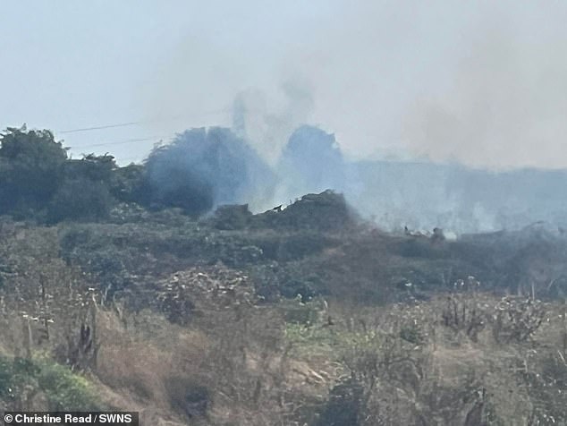 Steaming garbage coming out of the landfill, causing an unbearable stench for locals