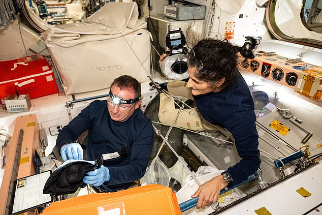 NASA astronauts Butch Wilmore and Suni Williams, commander and Boeing crew flight test pilot respectively, inspect safety hardware aboard the ISS on August 9, 2024.