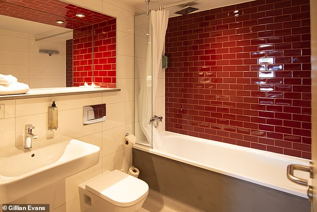 Here you can see the room's private bathroom, which comes equipped with a shower over the tub.