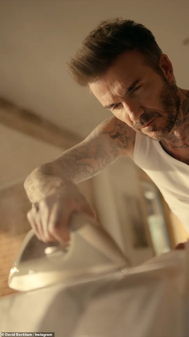 In the clip, the Inter Miami CF co-owner steam-irons a white shirt while showing off his tattoos in a white vest.