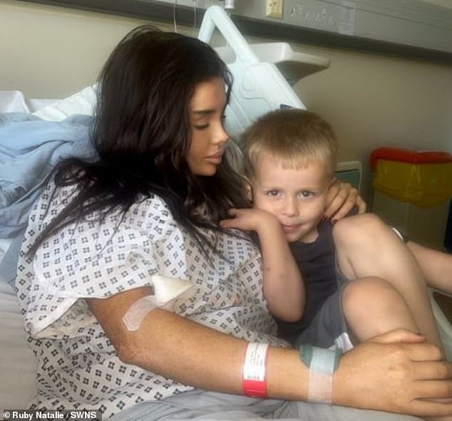 Ruby (left) pictured with hero JJ (right) in his hospital bed after the 999 call that saved his life.