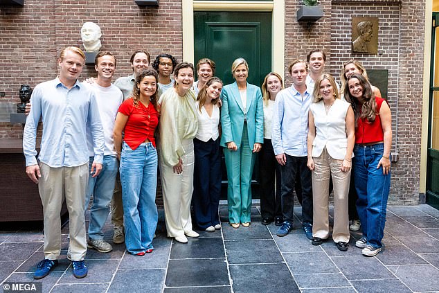 The Dutch royal smiled as she posed for a photograph with members of the organisation.