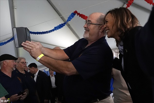 Harris poses for a selfie with a union worker