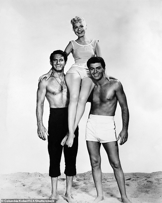 Darren rose to fame and became known as a teenage heartthrob after landing the role of a surfer named Moondoggie in the 1959 romantic comedy Gidget; pictured: Cliff Robertson, Sandra Dee, James Darren in a promotional image for Gidget from 1958