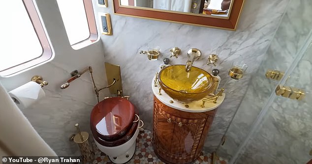 To top it off, there's a marble-clad bathroom, with a shower, a frosted window for privacy, a glass sink, and an old-school toilet.