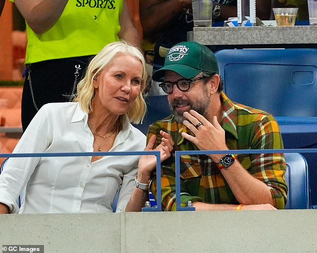 Australian tennis coach Rennae looked chic in a textured white shirt and a layer of accessorised gold necklaces as she chatted to Jason in the stands.