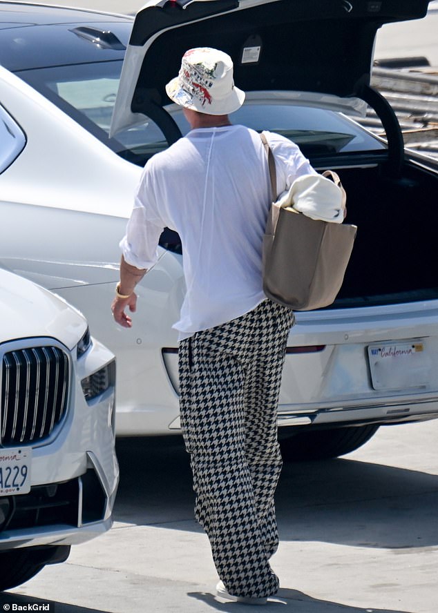 Brad looked relaxed and happy as he walked, and the star completed his travel outfit with a simple white T-shirt, dark sunglasses and sneakers.