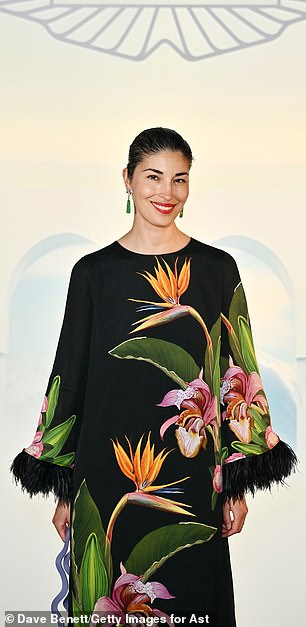 Caroline Issa wore a daring floral print dress with feathered cuffs.