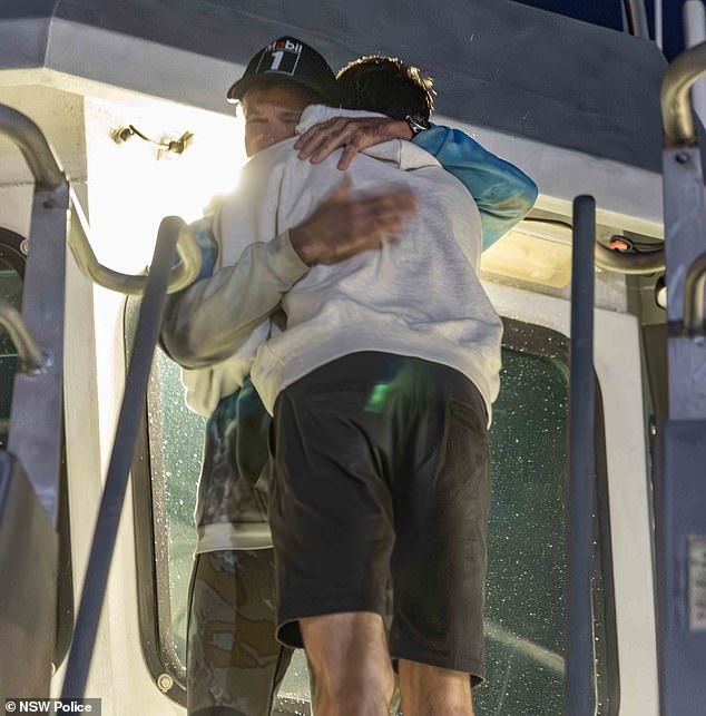 The family greeted the couple as they arrived on the Nemesis in Balmain at around 6.30pm on Tuesday (pictured, Brett hugging a loved one).