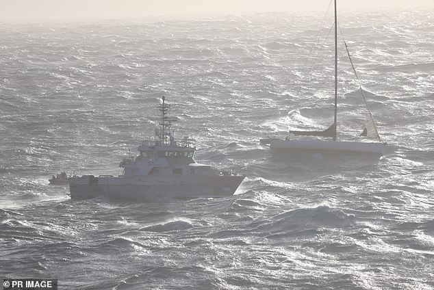 The yacht Spirit of Mateship (pictured right) was taking on water and had lost its rudder. The police boat Nemesis (pictured middle) arrived at around 3am on Tuesday and made contact with the crew.