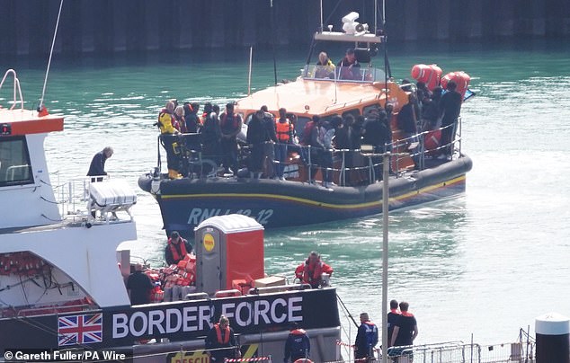 A group of people believed to be migrants are being taken to Dover, Kent, aboard an RNLI lifeboat following an incident with a small craft in the Channel on Tuesday.