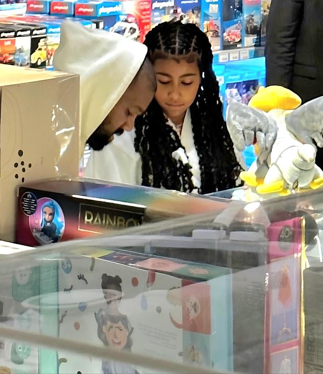 Kanye could be seen sweetly leaning down to get on North's level as she looked at some of the items in the store.