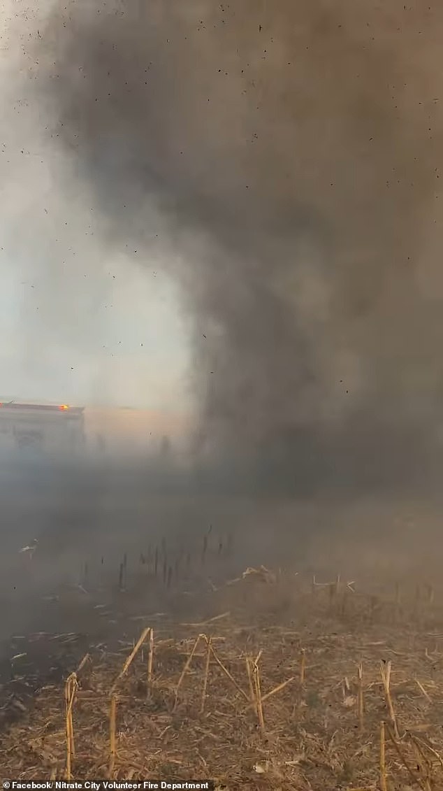 An 11-second video shows the sight firefighters encountered as the huge plume of smoke swirled debris around the field.