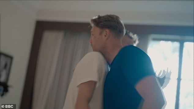 Flintoff hugs one of the teenagers as he holds one-on-one conversations with all of them to discuss their worries and anxieties as they prepare to return to the UK from their trip.