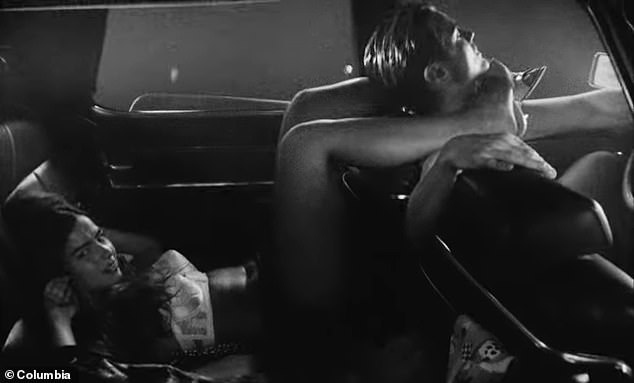 In the video, which is mostly black and white and has 2.9 million views on YouTube, Rae did her best to capture Lana Del Rey's moody, mature sound and look as she writhed in a car with actor and model Drew Van Acker (right).