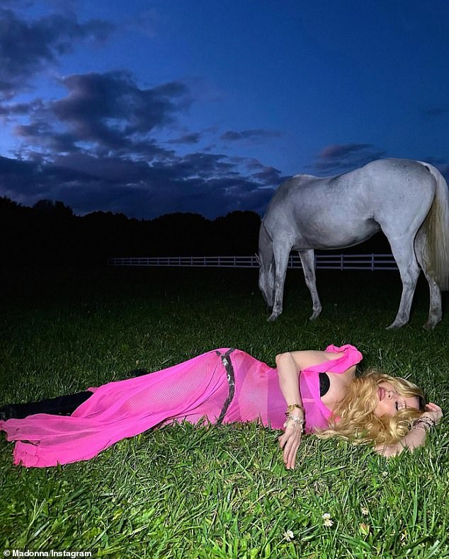 Another photograph showed her lying in the grass while Roller grazed nearby.