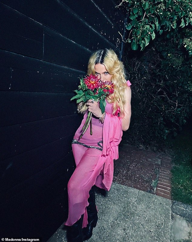 The carousel continued with a photo of her smelling a bouquet of pink flowers.