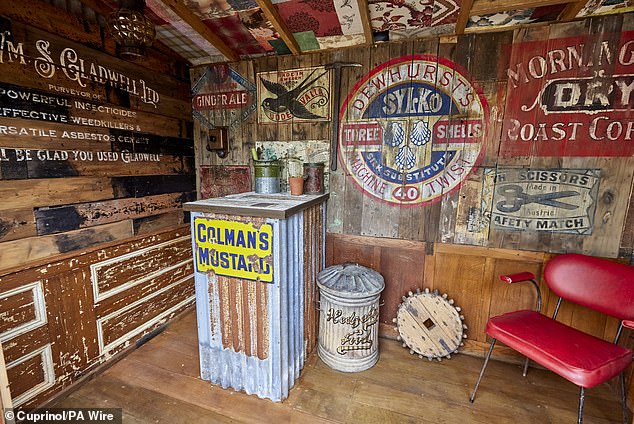 Wayne's shed, where he keeps his gardening tools, is also furnished with a vintage red leather chair and a high table.