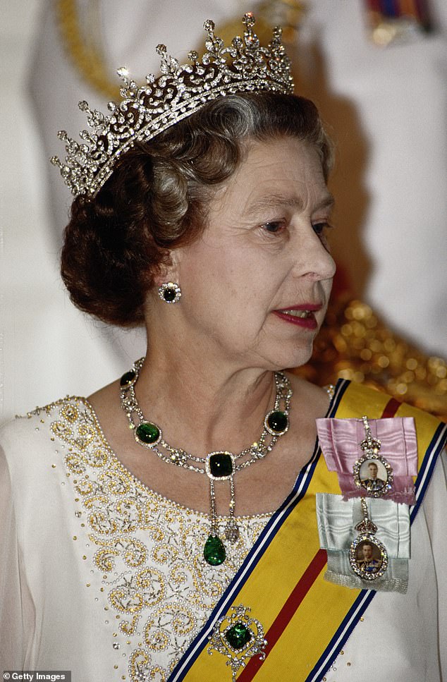 The late Queen is pictured wearing her Delhi Durbar Collar, which features the Cullinan VII, for a state banquet in Singapore in 1989.