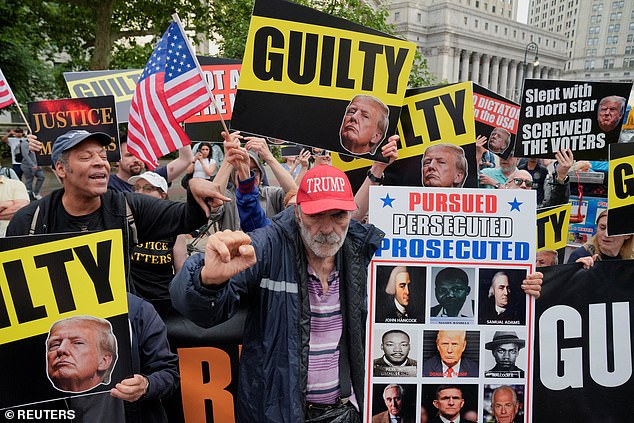 Protesters hold signs and flags in front of Manhattan Criminal Court in May.