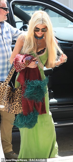 She carried her essentials in a large leopard-print bag.