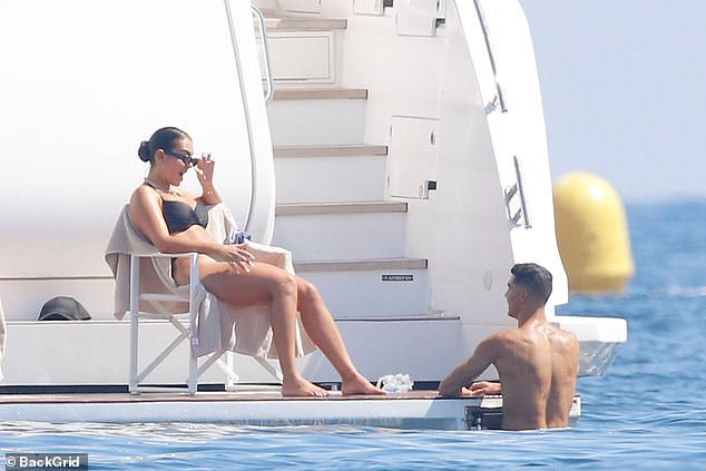 Georgina took a sip of water as Ronaldo chatted with her after their swim.