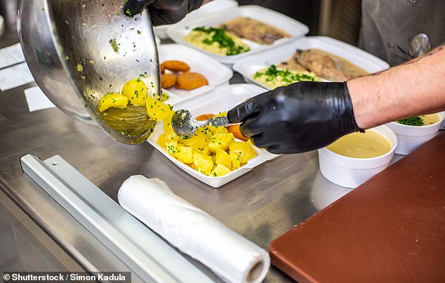 It is against Australian food safety laws to have live animals near food handling areas and where food is served (pictured is a stock image of a cook serving takeaway food in a pub)